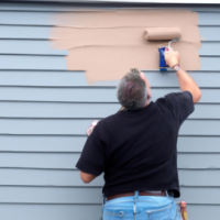 A man painting a house